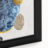 Close-up of a framed canvas wall art featuring an abstract design of colorful strokes and lines, showcasing vibrant hues of blue, orange, and yellow for modern decor.