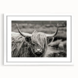 Framed wall art featuring a whimsical cow design with a white mat, set against a sleek black frame, ideal for animal lovers and modern decor enthusiasts.