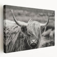 Stretched canvas artwork showcasing a vibrant cow design against a colorful background, ideal for animal-themed home decor and wall art collections.