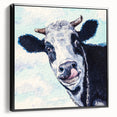 Framed canvas wall art showcasing a black and white cow design, set against a minimalist background, perfect for modern home decor. Ideal for animal lovers and rustic themes.
