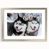 Framed wall art collection featuring a striking design of wild dogs in a natural setting, highlighted by a sleek silver frame and white mat, perfect for animal lovers.