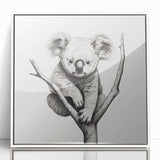 Framed wall art featuring a whimsical koala design, set in a sleek white frame with acrylic glass. Perfect for nature-themed decor, showcasing vibrant colors and playful details that capture the essence of Australian wildlife. Ideal for animal lovers and modern home aesthetics.