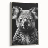 Framed canvas wall art showcasing a serene koala design in natural colors, set against a silver frame, perfect for wildlife-themed decor in modern interiors.