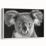 Framed wall art showcasing a koala design on canvas, featuring vibrant colors and a white frame, ideal for animal lovers and nature-themed decor.