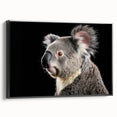 Framed wall art featuring a serene koala design on canvas, showcasing vibrant colors and a sleek black frame, ideal for nature enthusiasts and home decor.