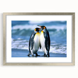 Framed wall art featuring a charming penguin design in a silver frame with matting, perfect for adding a playful touch to home decor.