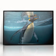 Framed wall art featuring a playful penguin design in a modern black frame, showcasing vibrant colors and whimsical details, perfect for animal lovers and home decor.