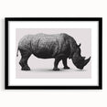 Black-framed wall art showcasing a striking rhinoceros design, set against a clean background, perfect for wildlife enthusiasts and modern home decor.