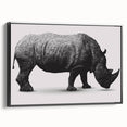 Framed wall art featuring a side view of a rhinoceros, showcasing intricate details and artistic design in black tones, ideal for wildlife enthusiasts and home decor.