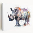 Stretched canvas wall art depicting a side view of a majestic rhinoceros in a natural habitat, showcasing detailed textures and earthy tones, ideal for wildlife enthusiasts.