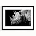 Black-framed wall art featuring a striking rhinoceros design, showcasing intricate details and vibrant colors, perfect for animal lovers and home decor enthusiasts.