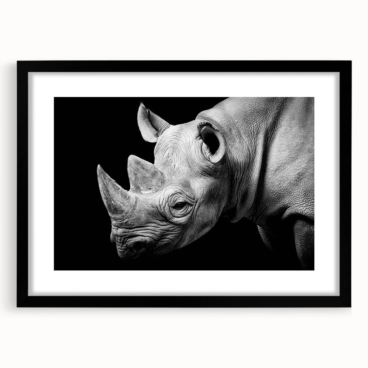 Black-framed wall art featuring a striking rhinoceros design, showcasing intricate details and vibrant colors, perfect for animal lovers and home decor enthusiasts.