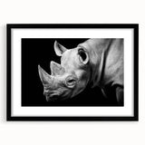 Black-framed wall art featuring a striking rhinoceros design, showcasing intricate details and vibrant colors, perfect for animal lovers and home decor enthusiasts.