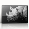 Framed wall art featuring a striking black and white rhinoceros design, showcasing intricate details and modern aesthetics, perfect for wildlife enthusiasts.