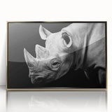 Framed wall art featuring a striking front view of a rhinoceros in a gold-acrylic design, perfect for wildlife enthusiasts and modern decor.
