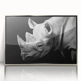 Framed acrylic wall art showcasing a front view of a rhinoceros, featuring intricate details and a silver finish, perfect for wildlife enthusiasts and modern decor.