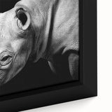 Close-up of a framed canvas wall art featuring a detailed illustration of a rhinoceros in a natural habitat, showcasing rich colors and textures, perfect for wildlife enthusiasts.