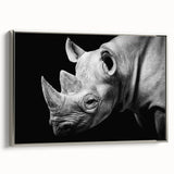 Framed wall art featuring a silver side view of a rhinoceros, showcasing intricate details and textures, perfect for animal lovers and home decor enthusiasts.