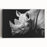 Front view of a vibrant stretched canvas artwork depicting a rhinoceros in a wild landscape, showcasing detailed textures and earthy tones, perfect for animal lovers and home decor enthusiasts.