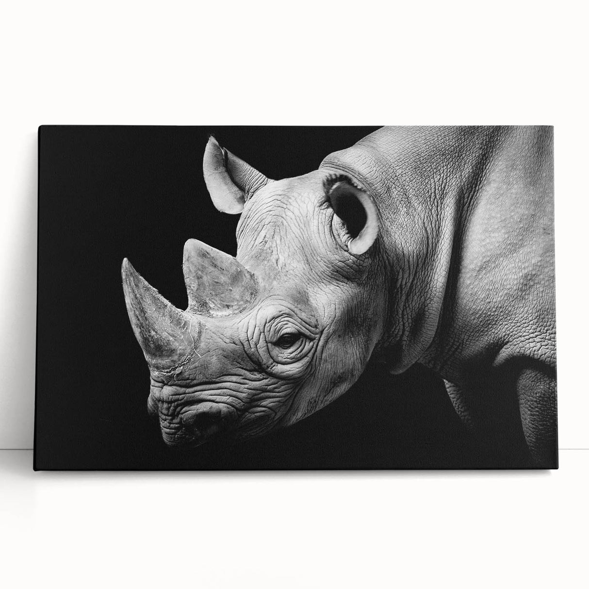Stretched canvas wall art featuring a striking rhinoceros design, showcasing intricate details and vibrant colors, ideal for wildlife enthusiasts and home decor.