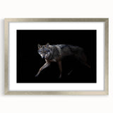 Framed wall art featuring a striking silver mat showcasing a wolf design, perfect for wildlife enthusiasts, set against a contemporary backdrop.