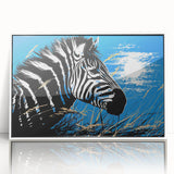 Framed wall art showcasing a striking zebra design in black and white, displayed in a sleek white frame, ideal for adding a modern touch to home decor.