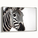 Framed wall art featuring a striking zebra design in a silver frame, showcasing vibrant black and white stripes against a minimalist background, perfect for animal-themed decor.