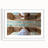 Abstract art print of ancient ruins in muted earth tones, framed with a white mat, suitable for dining room decor.