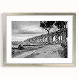 Textured art depicting abstract arches in muted gray, framed in silver, ideal for modern bedroom ambiance.