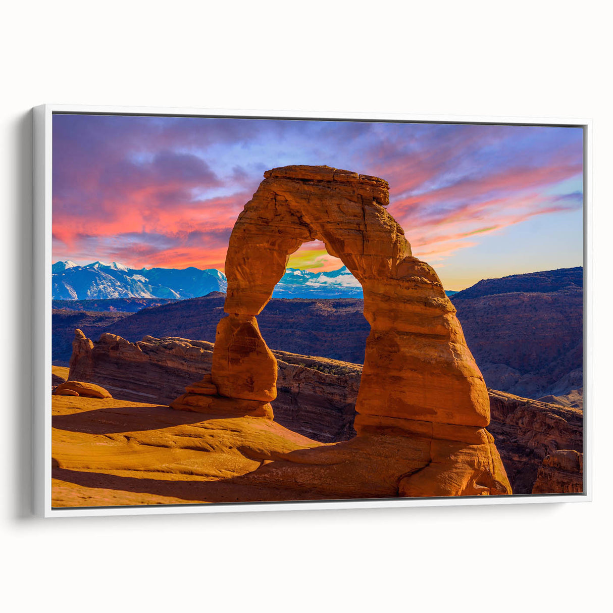Framed canvas of a vintage poster featuring colorful landscape art paintings with black wall art accents.