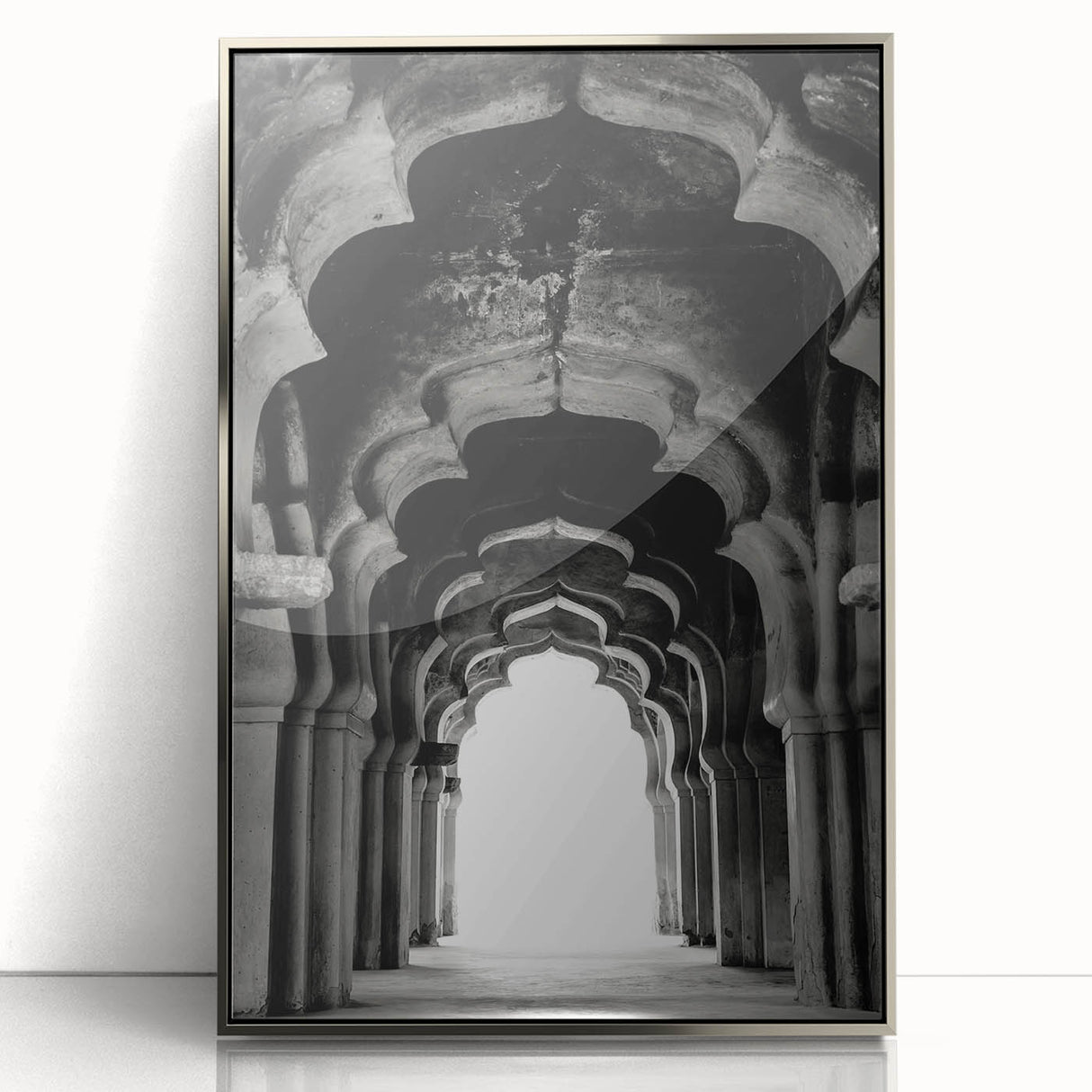 Art deco poster featuring symmetrical arch designs in muted silver tones on a framed acrylic.