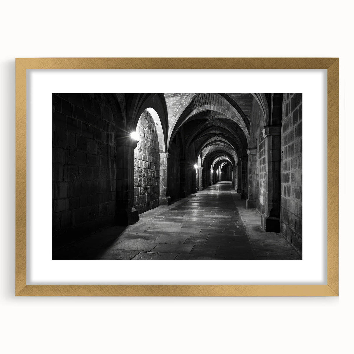 Abstract art print featuring symmetrical arch designs in muted gold and white tones on a framed canvas.