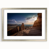 Textured abstract art print featuring curved architectural forms in neutral shades, silver-framed with mat.