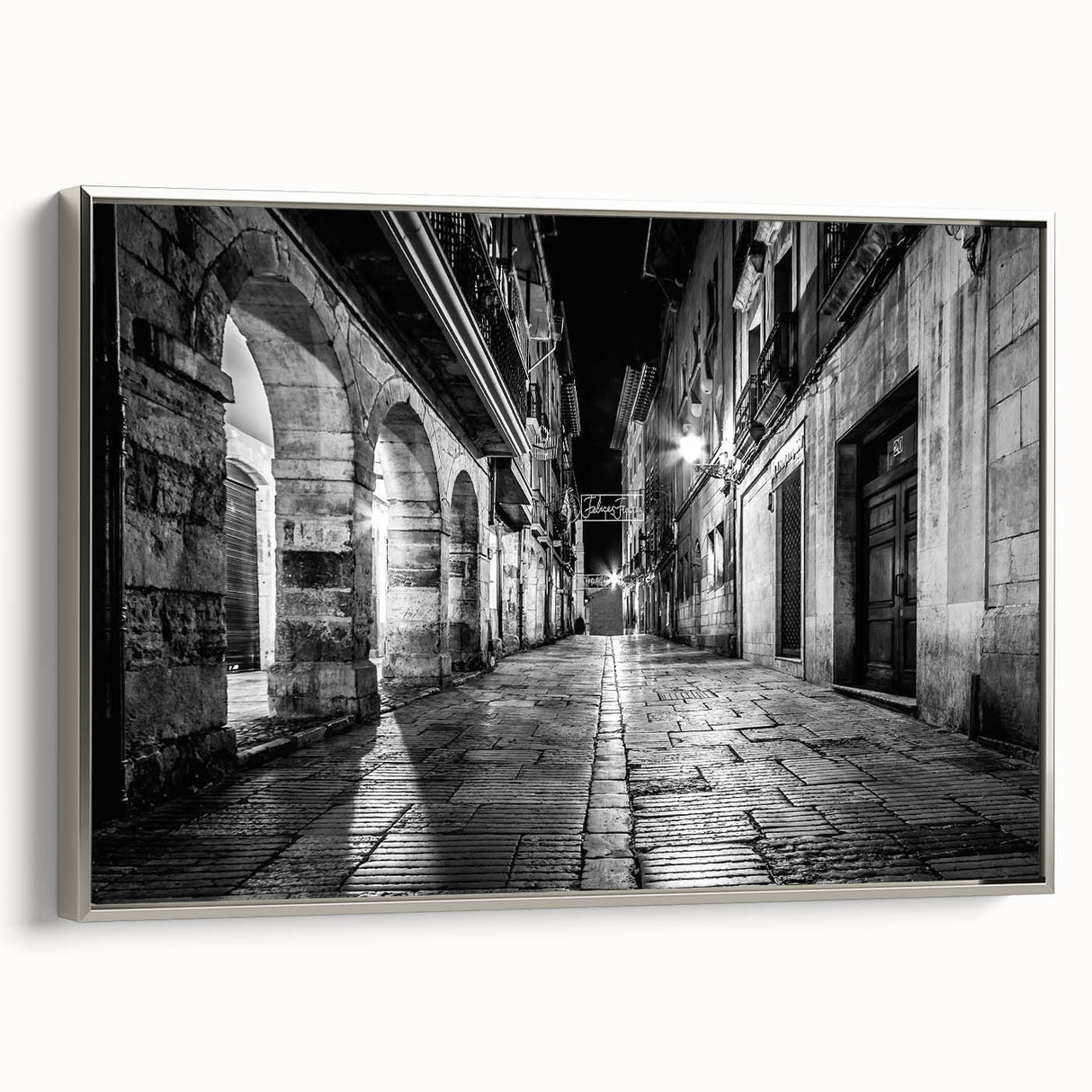 Framed canvas featuring a series of arches in a landscape painting, rendered in black with colorful accents.