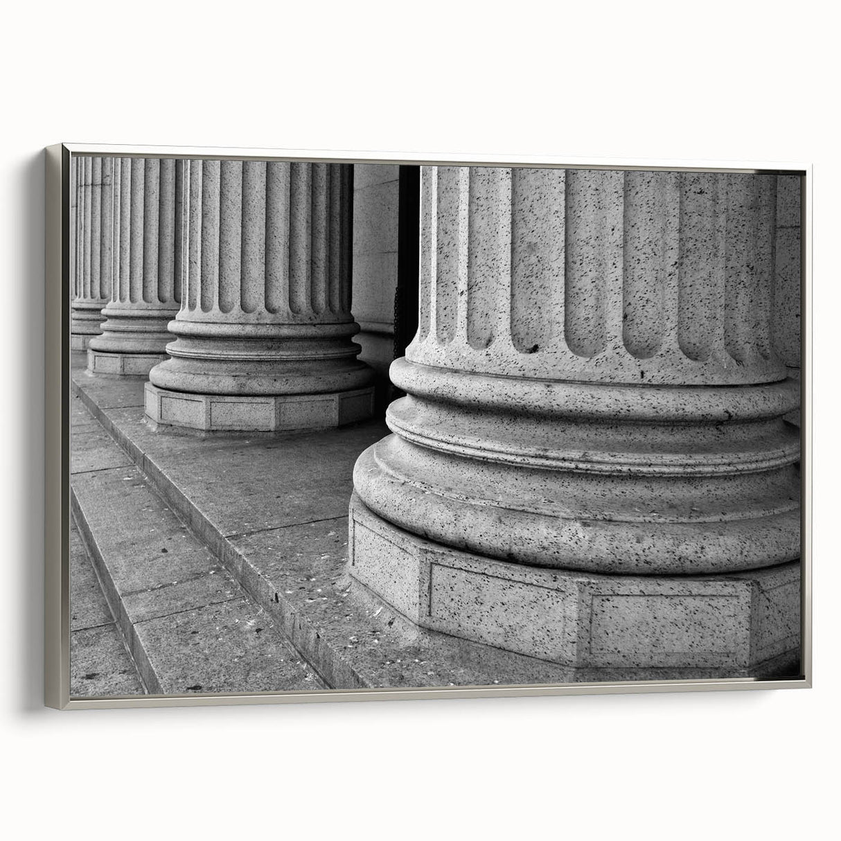 Framed canvas featuring a landscape painting of classical columns in black with colorful accents, ideal for office decor.