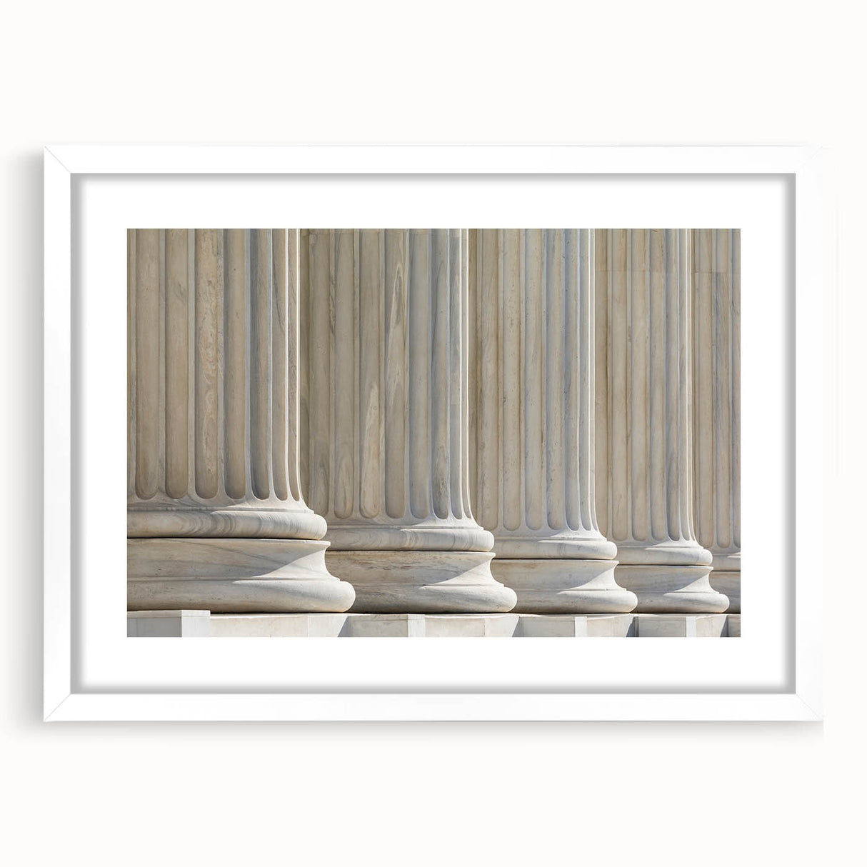 Abstract art print featuring symmetrical column designs in black and white, framed in white.