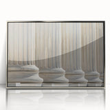 Mid-century modernist art featuring silver-framed acrylic print of architectural columns in muted tones.
