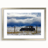 Textured abstract art print in muted gray and white, framed in silver, ideal for modern bedroom decor.