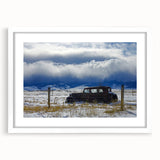 Abstract art print depicting a derelict building in muted gray and blue tones on a white framed canvas.