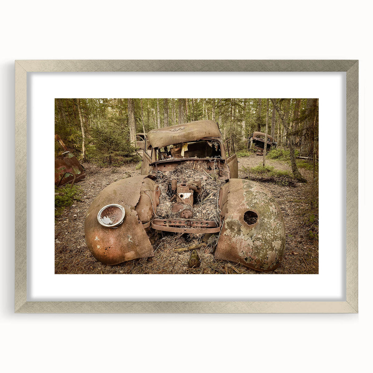 Textured art print of abstract, dilapidated buildings in muted gray and silver, framed with a silver mat.