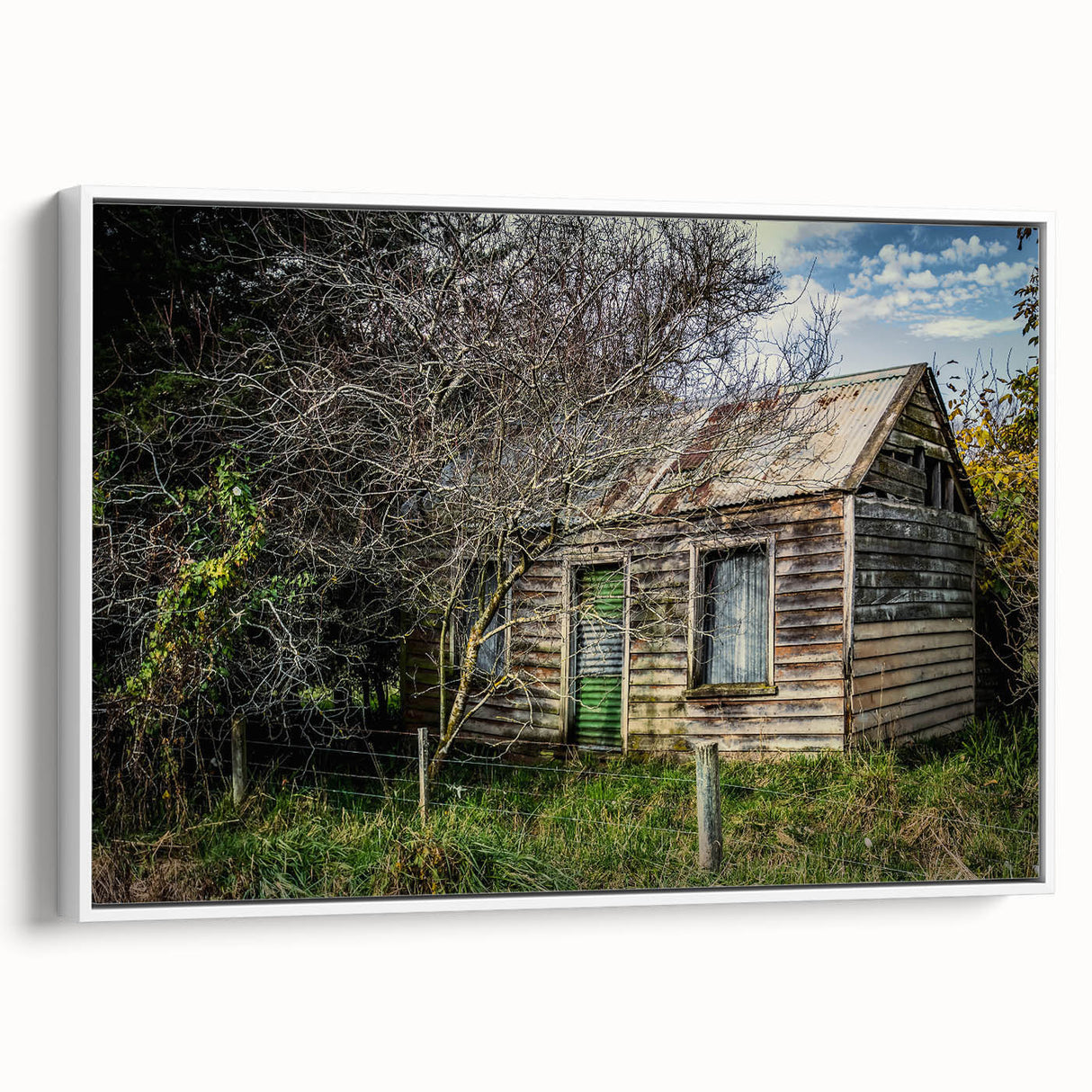 Vintage poster art of a derelict building on a framed canvas, featuring a black and colorful palette.