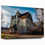Large abstract wall art on acrylic glass depicting a derelict building, in muted earth tones.