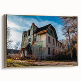 Framed canvas featuring a landscape art painting of a derelict building in muted earth tones.