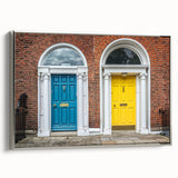 Vintage poster art of an architectural door design in muted black and colorful accents on a framed canvas.