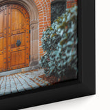 Close-up of black wall art featuring a textured, colorful door design on a framed canvas.