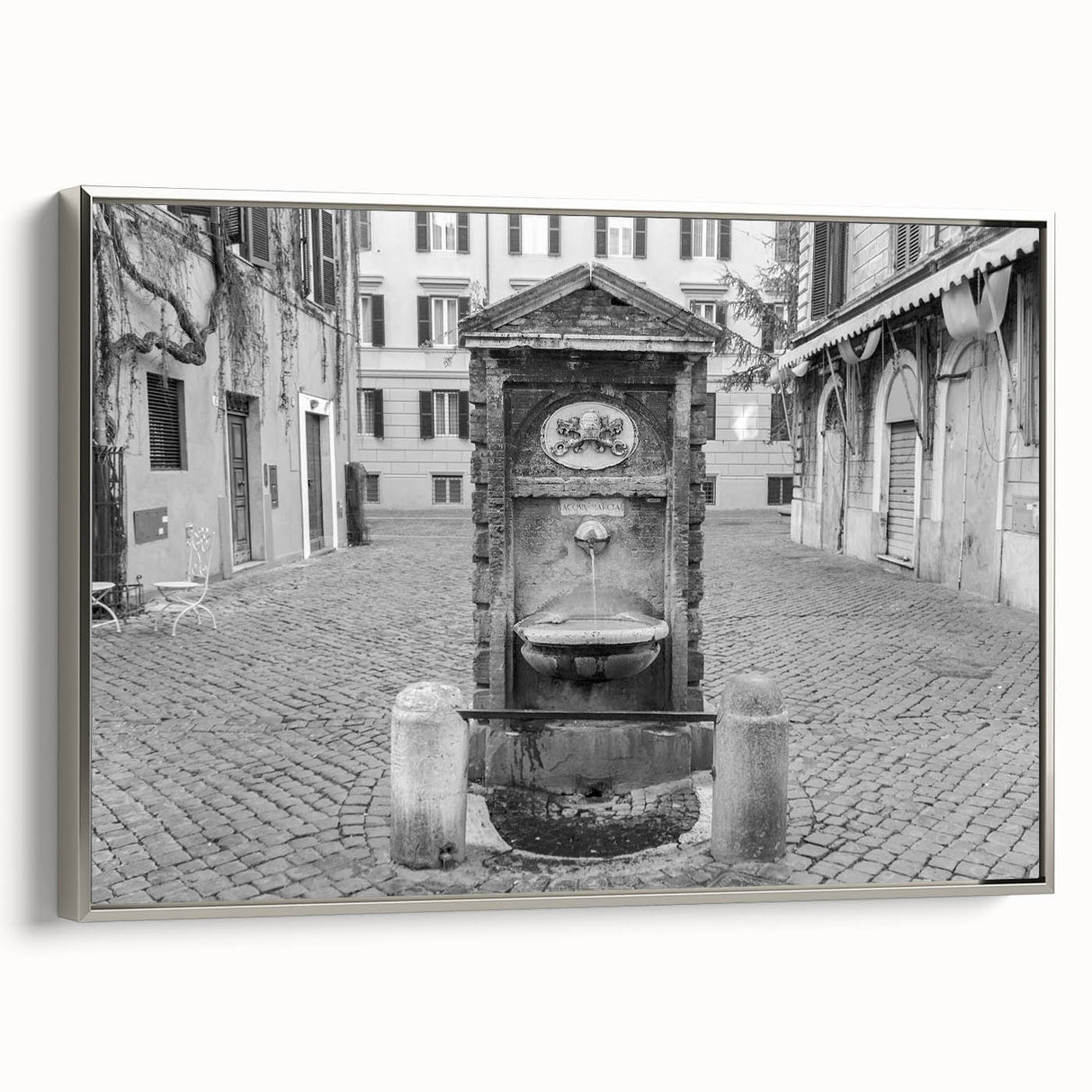 Framed canvas of a vintage-style landscape painting featuring a fountain design, in muted colors.