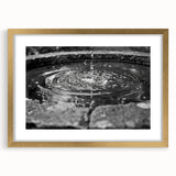 Extra large abstract art print of a textured fountain design in gold tones, framed with mat, ideal for living room decor.