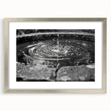 Textured art print featuring abstract design in muted gray and blue tones, framed in silver, ideal for bedroom art.