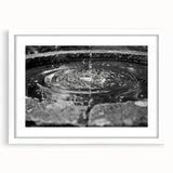 Abstract art print featuring a monochrome architectural fountain design on a white framed matte, ideal for dining room decor.