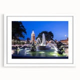 Abstract art print featuring a white fountain design on a black background, framed in white, ideal for dining room decor.